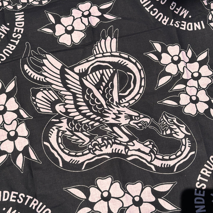 Black fabric with white tattoo-style designs of a swan and flowers, featuring &